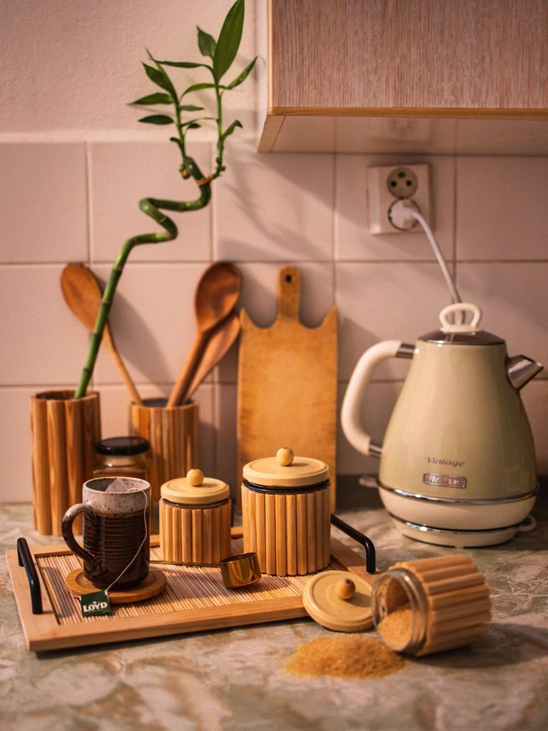 A bamboo canister of Liu An Gua Pian dark tea with broad flat leaves at the rim